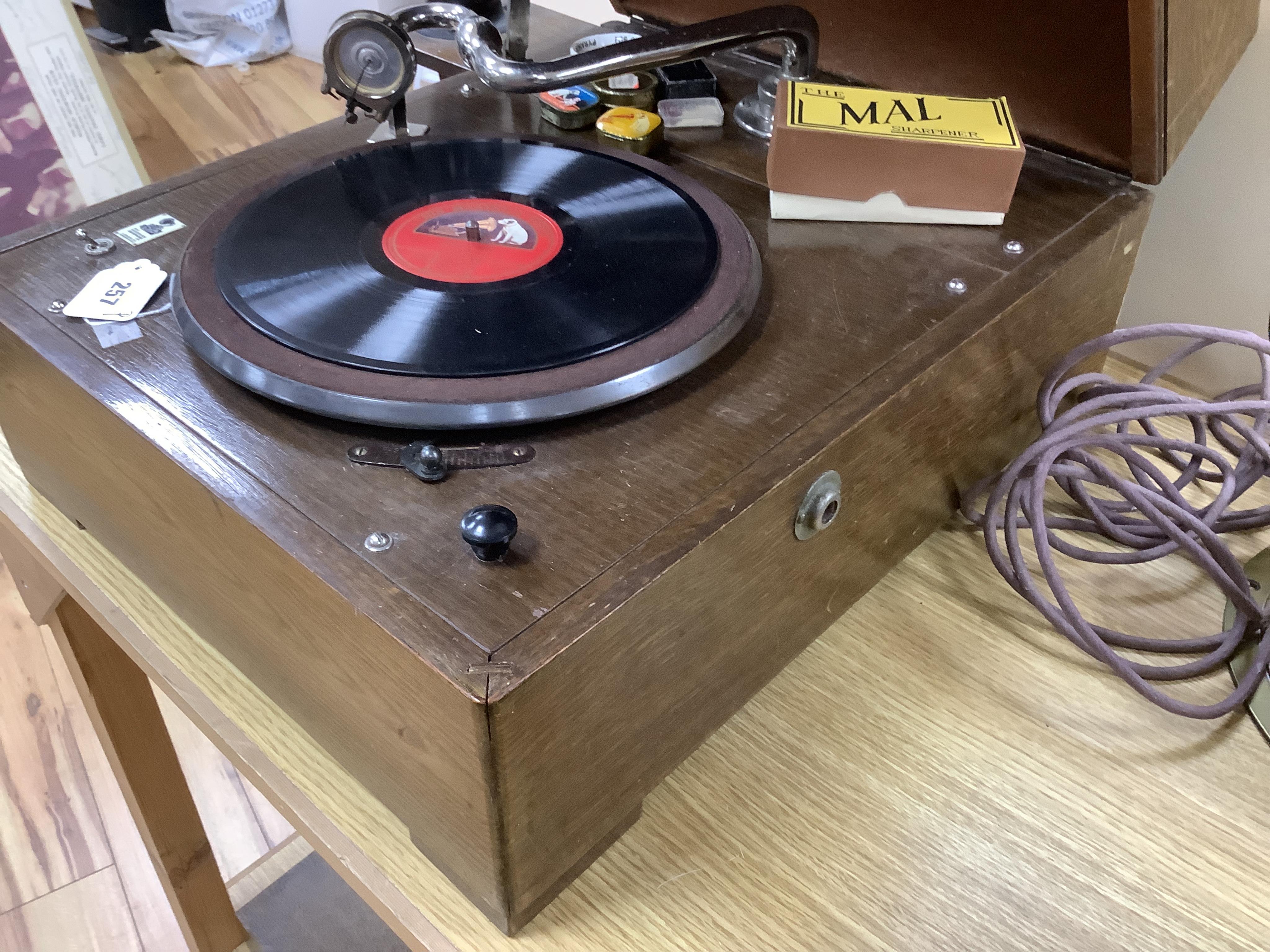 An EMG ‘Handmade Gramophone’ with electrically powered motor, in an oak veneered case with large papier-mâché horn, dimensions of the case; 44 x 53 x 27cm, diameter of the horn 56cm.